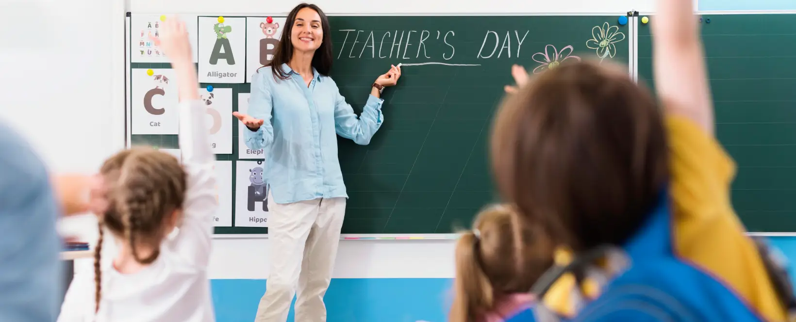 maestra explicando el dia del maestro en la pizarra